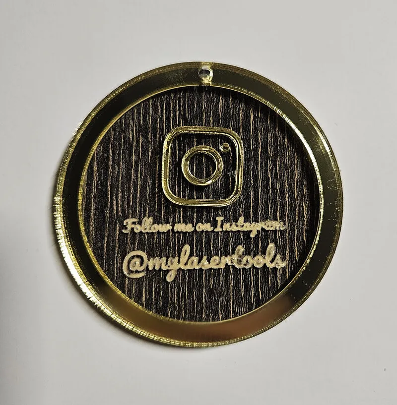 Multi-layer Instagram keychain made from black wood acrylic and gold mirror acrylic.